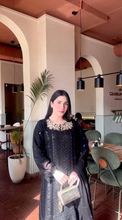 A Captivating Woman in a Black Dress Gracing the Ambiance