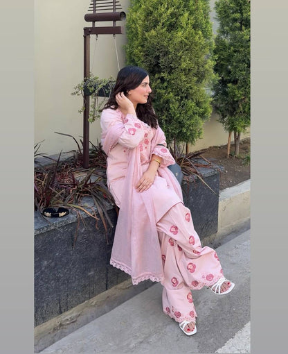 A Woman in Elegant Pink Attire Enjoying a Peaceful