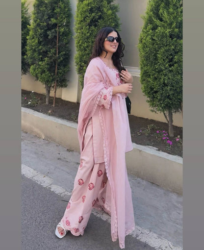 A Woman in Elegant Pink Attire Enjoying a Peaceful