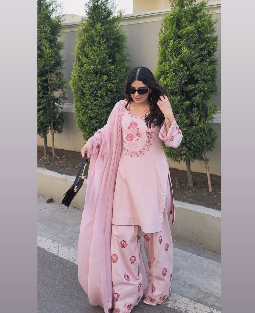 A Woman in Elegant Pink Attire Enjoying a Peaceful